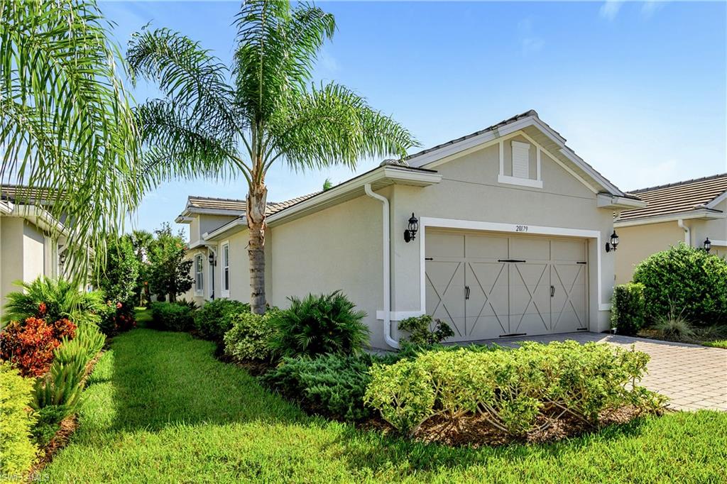 a front view of house with yard and green space