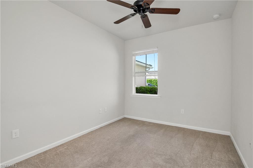 20179 Torch Key Way Estero, FL 33928 - Photo 11 of 25 an empty room with a window and a fan