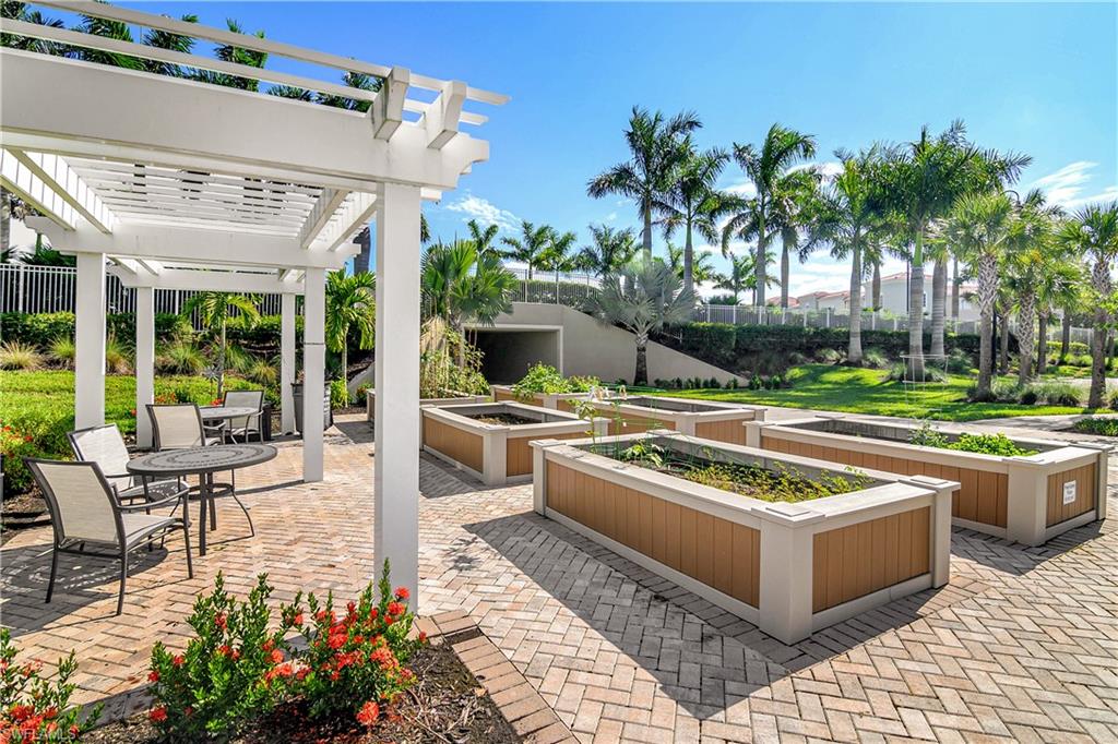 20179 Torch Key Way Estero, FL 33928 - Photo 22 of 25 a view of a swimming pool with chairs in patio