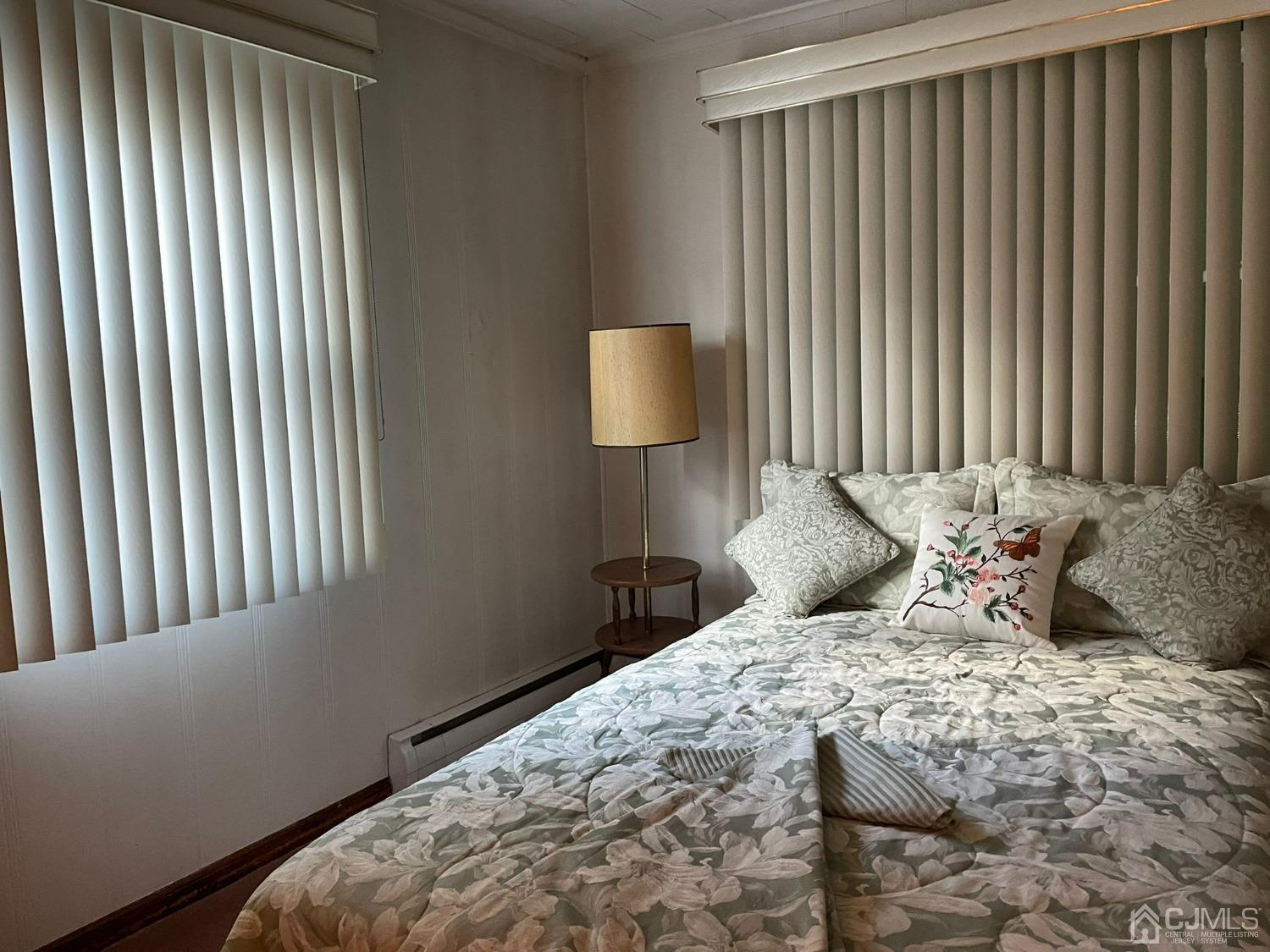 148 Oxford Road Colonia, NJ 07067 - Photo 3 of 9 a bedroom with a bed and a lamp