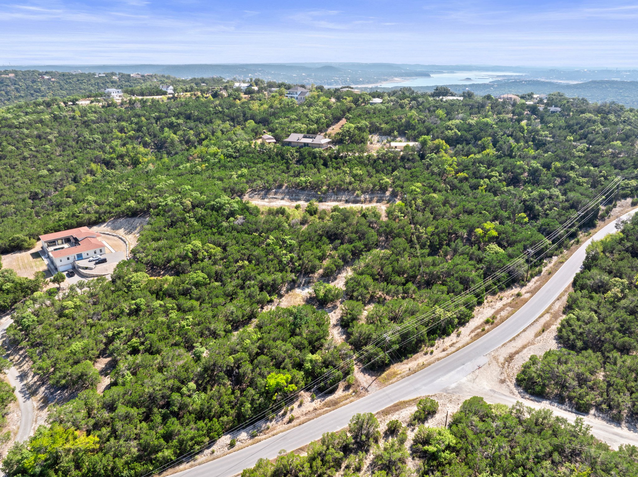 19201 West Reed Park Road Jonestown, TX 78645 - Photo 2 of 12 Aerial overview of property's location with a heavily wooded area