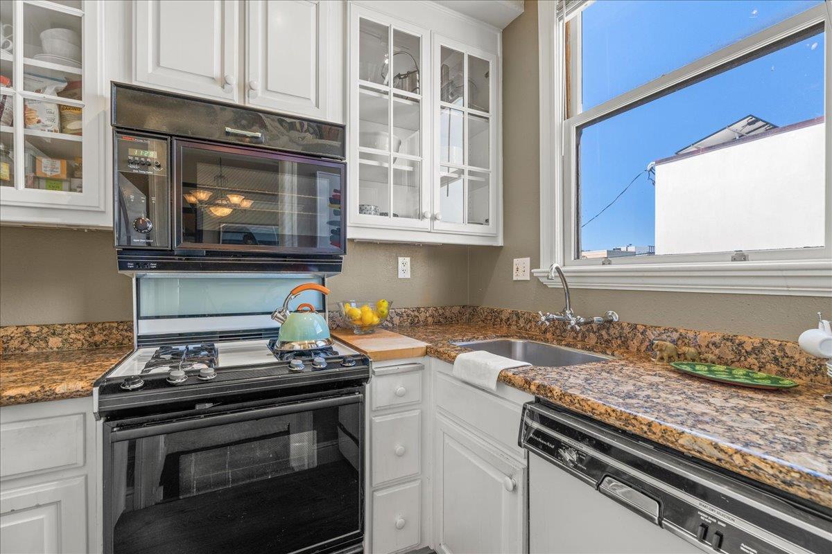 15 Rico Way, Unit 3 San Francisco, CA 94123 - Photo 18 of 46 a kitchen with granite countertop a stove and a sink