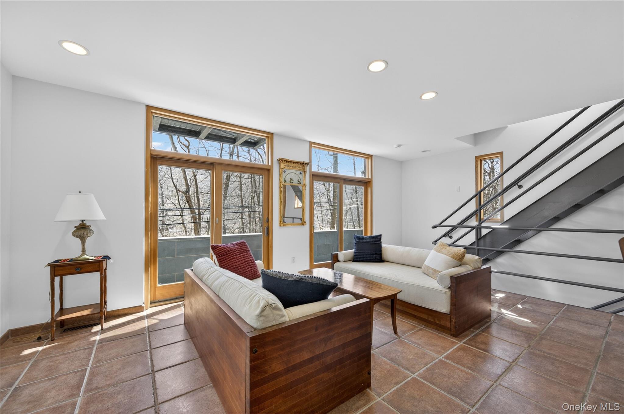 428 Harbor Road, Unit C Syosset, NY 11791 - Photo 16 of 29 Living area featuring large format terracotta-style tile flooring, recessed ceiling lighting, and a contemporary open-riser staircase with metal railings