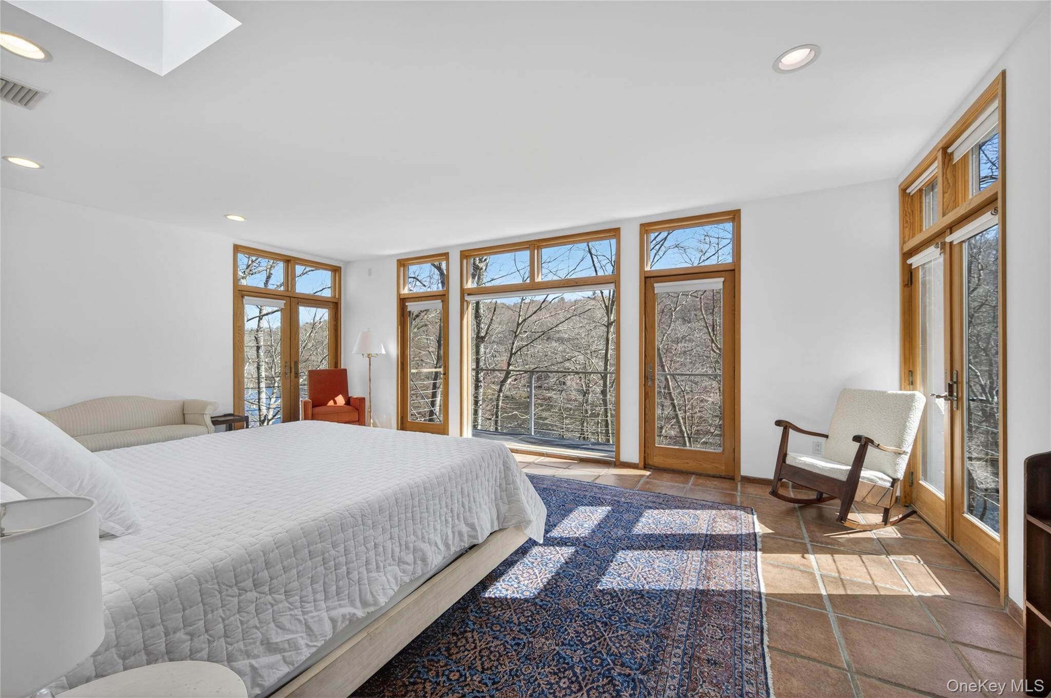428 Harbor Road, Unit C Syosset, NY 11791 - Photo 19 of 29 Spacious room featuring multiple large windows and glass-paneled doors with wood frames
