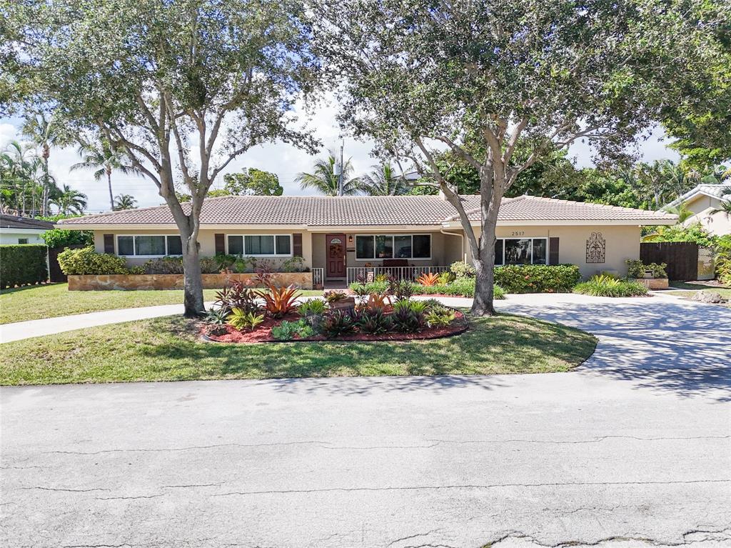 2517 Northeast 26th Terrace Fort Lauderdale, FL 33305 - Photo 1 of 42 a front view of a residential apartment building with yard and green space