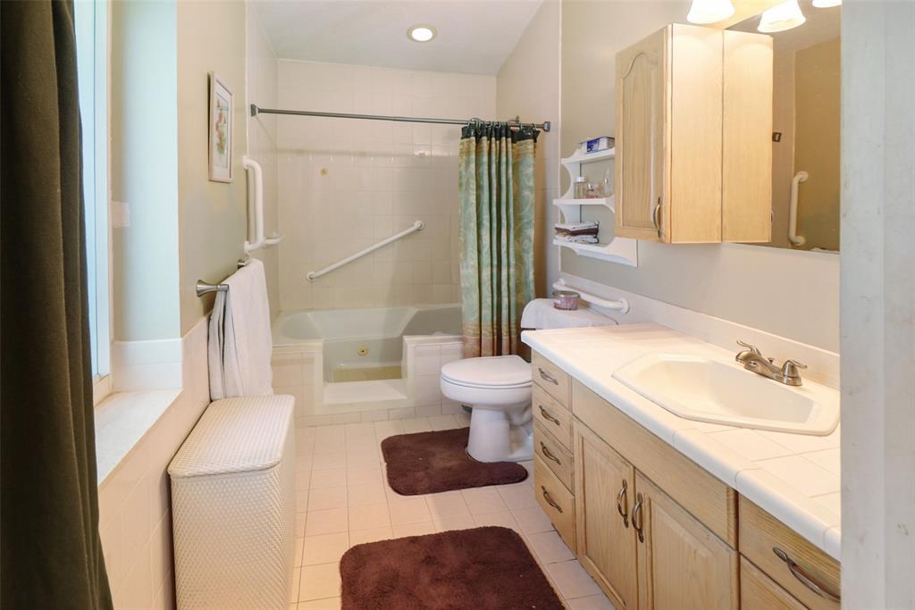 2517 Northeast 26th Terrace Fort Lauderdale, FL 33305 - Photo 14 of 42 a bathroom with a sink toilet and shower