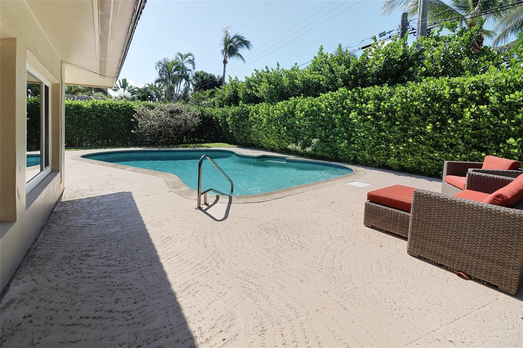 2517 Northeast 26th Terrace Fort Lauderdale, FL 33305 - Photo 23 of 42 a view of a swimming pool with a patio