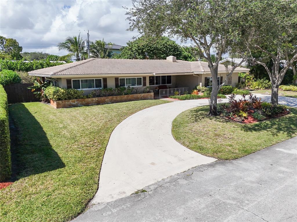 2517 Northeast 26th Terrace Fort Lauderdale, FL 33305 - Photo 33 of 42 a front view of a house with a yard