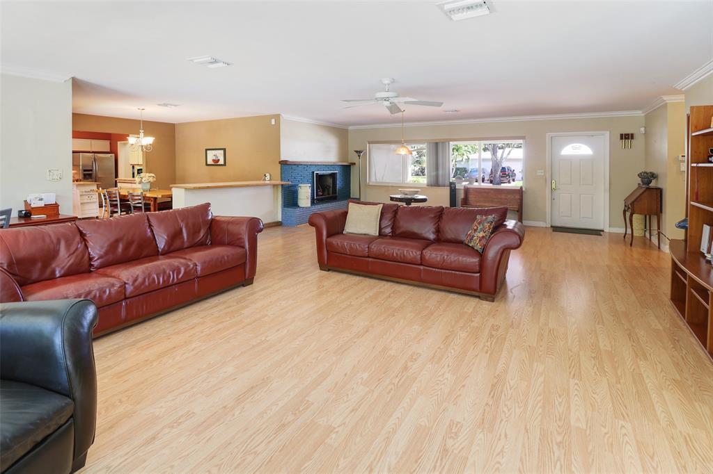 2517 Northeast 26th Terrace Fort Lauderdale, FL 33305 - Photo 8 of 42 a living room with a couch and a wooden floor