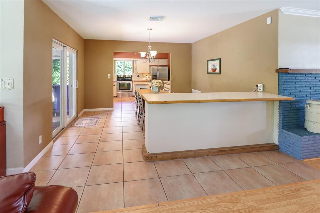 2517 Northeast 26th Terrace Fort Lauderdale, FL 33305 - Photo 9 of 42 a large white kitchen with a sink a counter space and a window