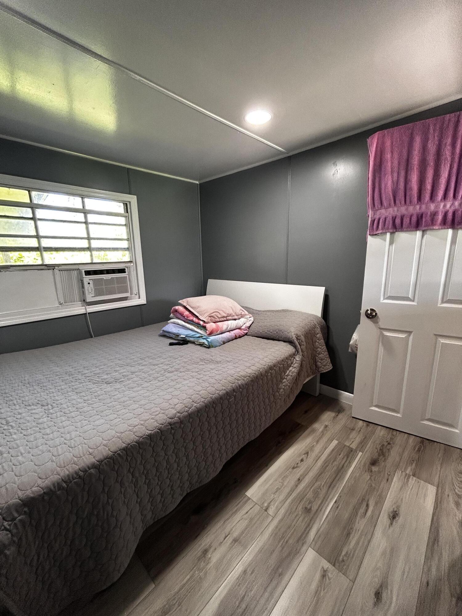 425 South Quebrada Street Clewiston, FL 33440 - Photo 11 of 56 a bedroom with a bed and a window