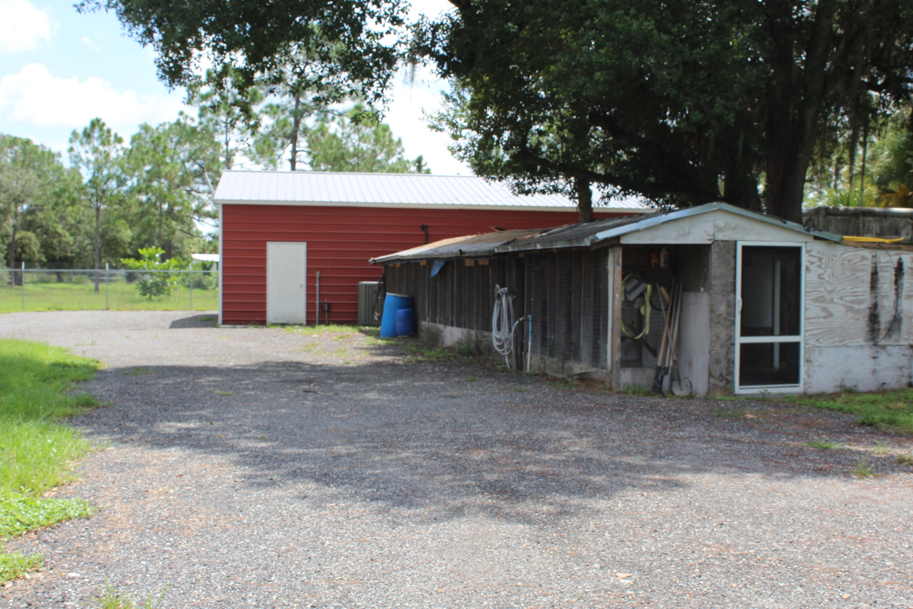 425 South Quebrada Street Clewiston, FL 33440 - Photo 20 of 56 a front view of a house with a yard and garage