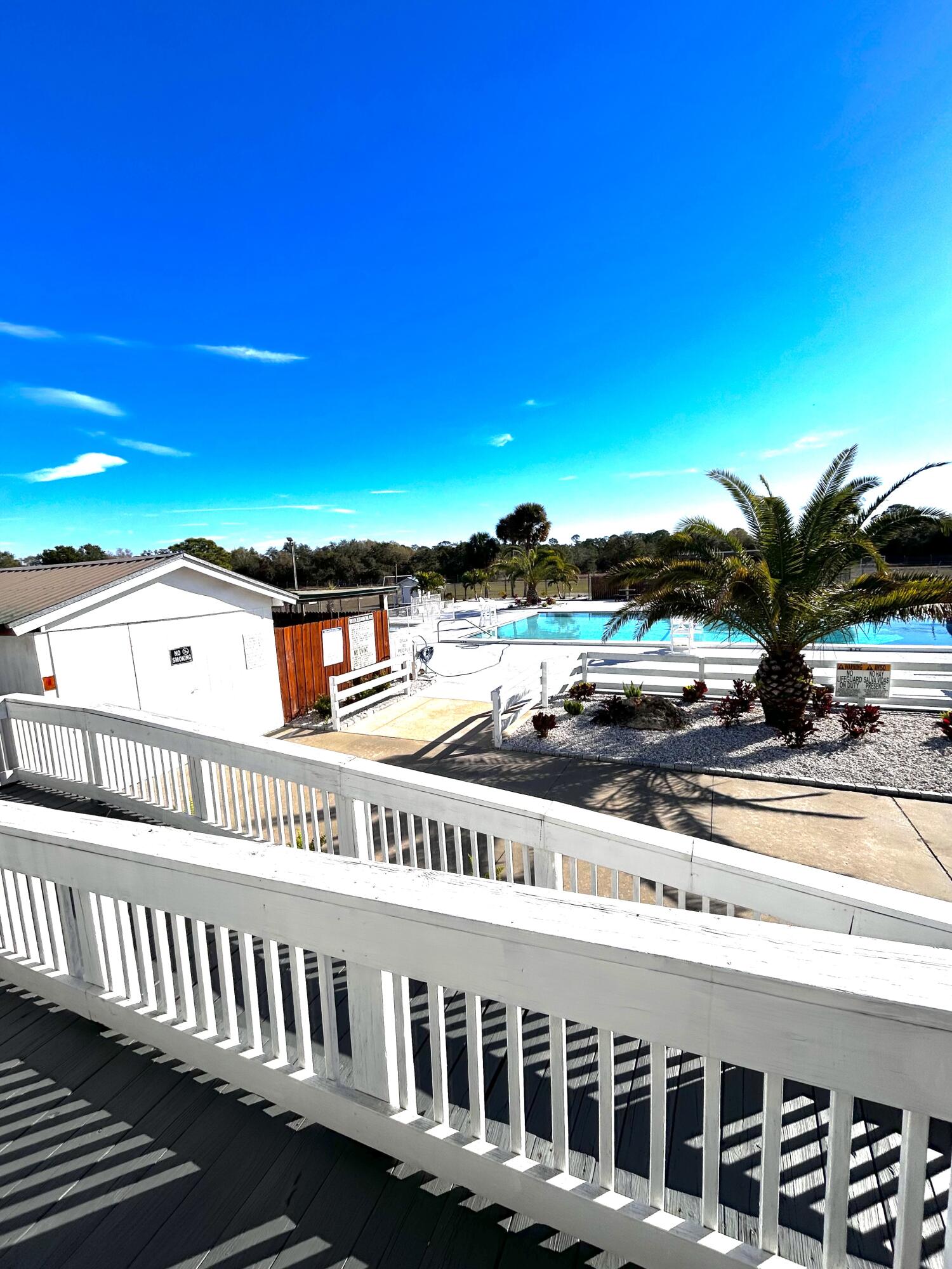 425 South Quebrada Street Clewiston, FL 33440 - Photo 35 of 56 a view of balcony with two chairs and a table