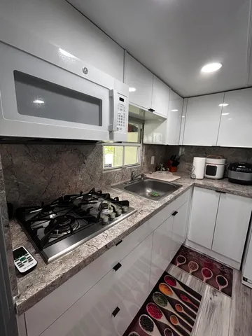 a view of a hallway with wooden floor and stairs
