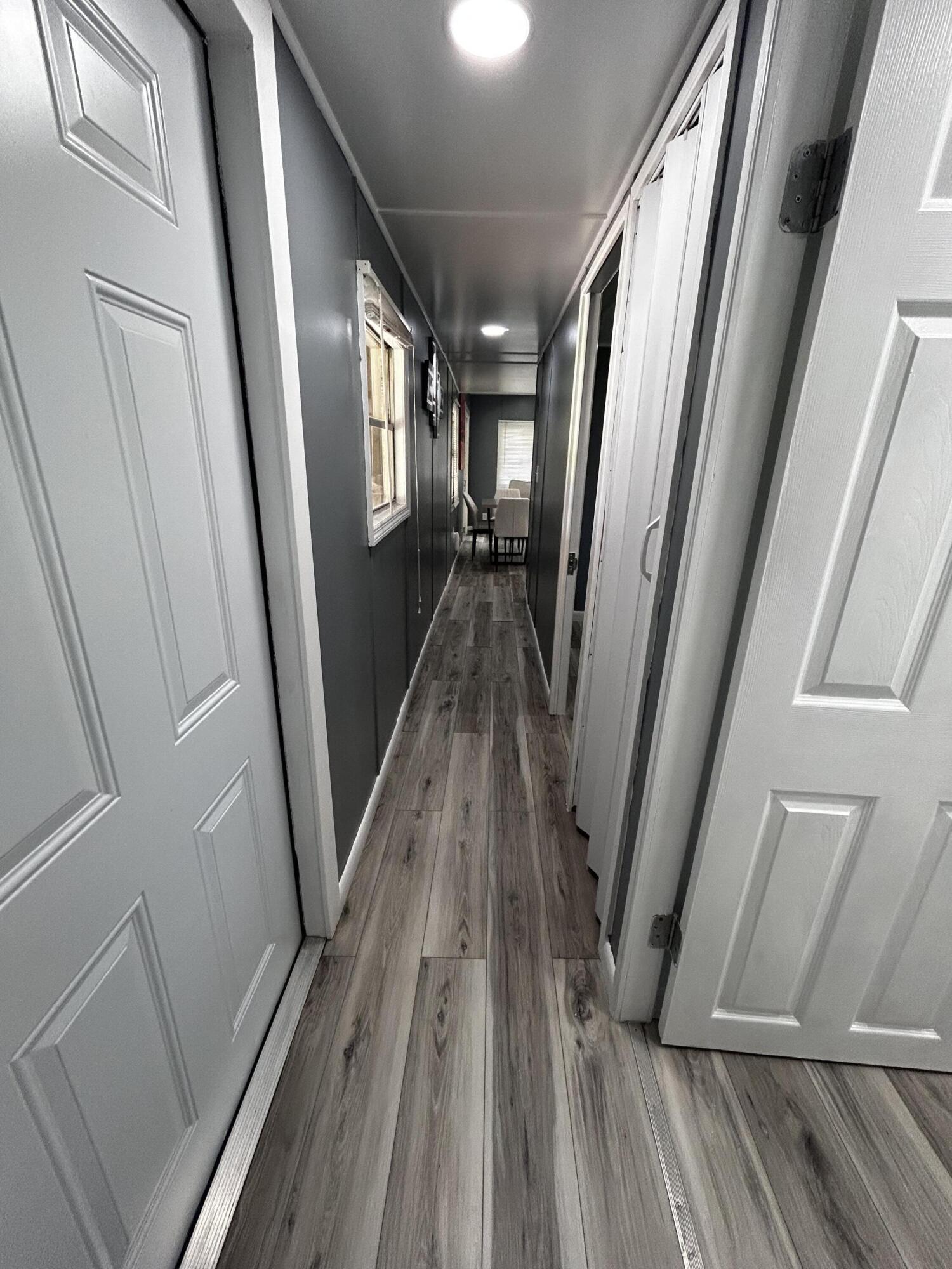 425 South Quebrada Street Clewiston, FL 33440 - Photo 9 of 56 a view of a hallway with wooden floor and stairs