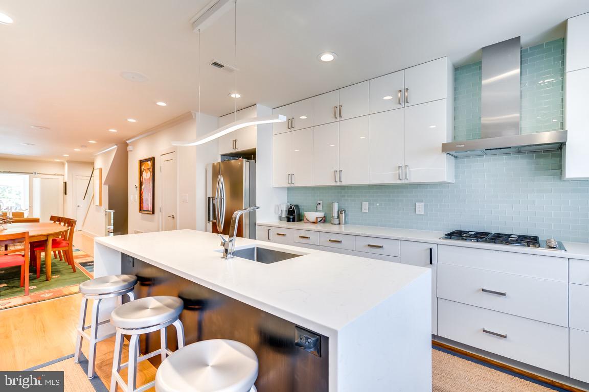 117 T Street Northwest, Unit 2 Washington, DC 20001 - Photo 13 of 32 a kitchen with stainless steel appliances kitchen island granite countertop a sink and cabinets