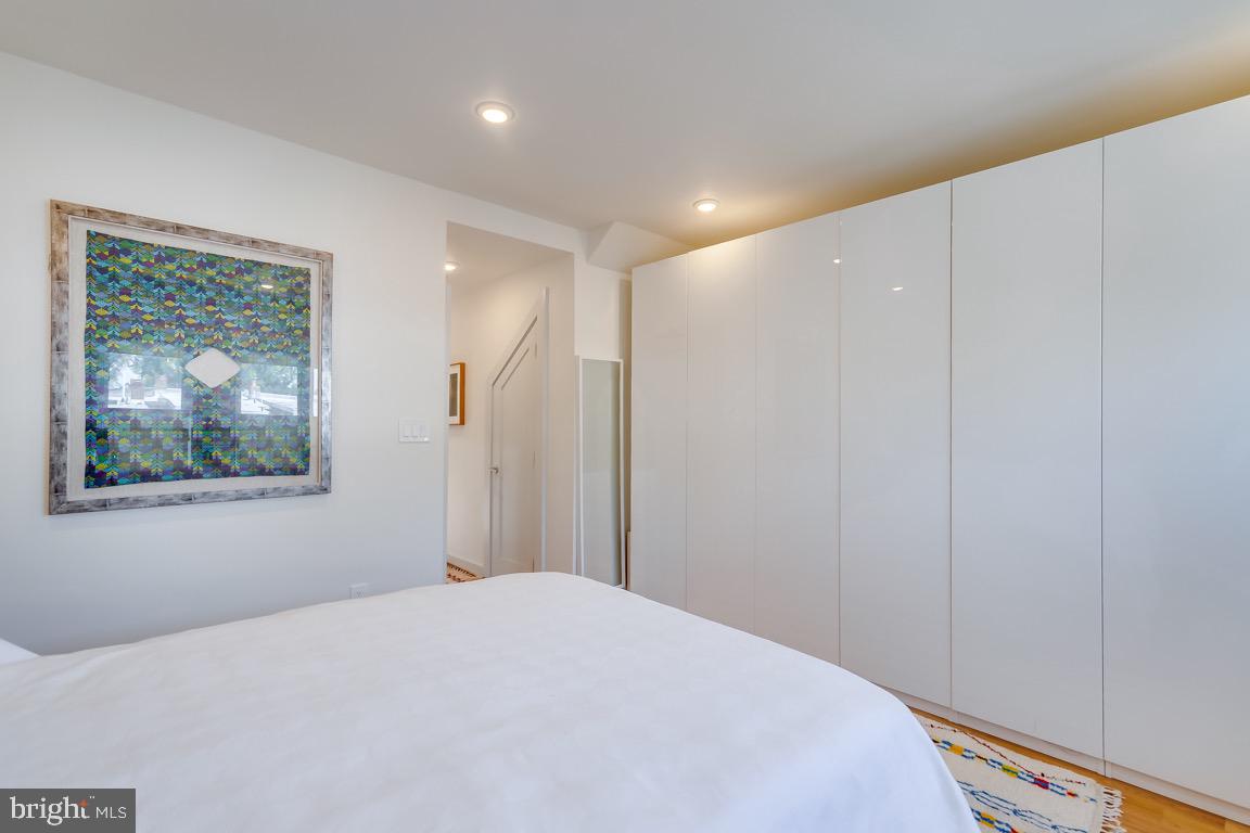 117 T Street Northwest, Unit 2 Washington, DC 20001 - Photo 21 of 32 a bedroom with a bed and a painting on the wall