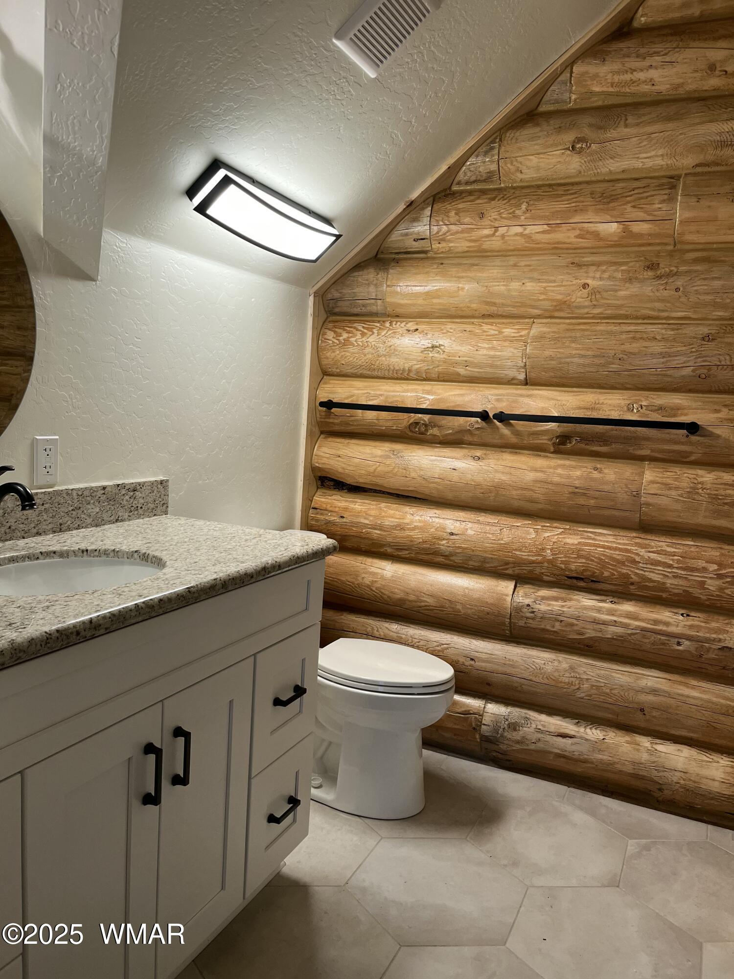 446 Becker Lake Road Springerville, AZ 85938 - Photo 17 of 18 a bathroom with a granite countertop sink and a toilet