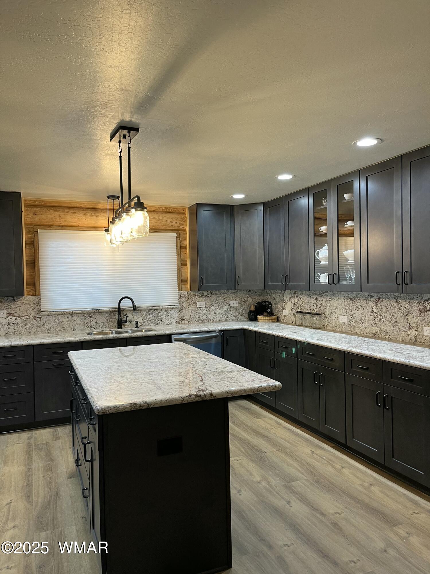 446 Becker Lake Road Springerville, AZ 85938 - Photo 6 of 18 a large kitchen with granite countertop a sink counter space and cabinets