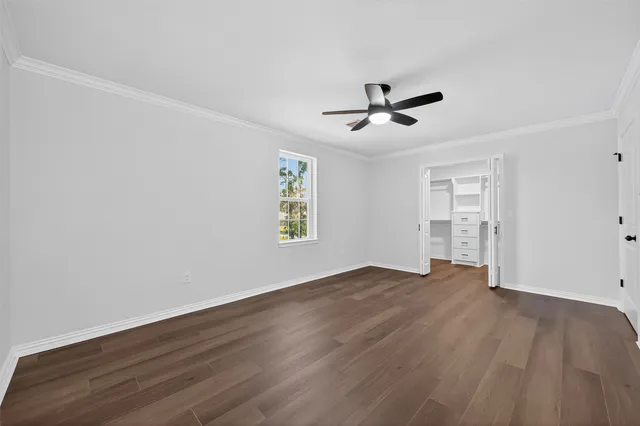 a view of walk in closet with empty racks