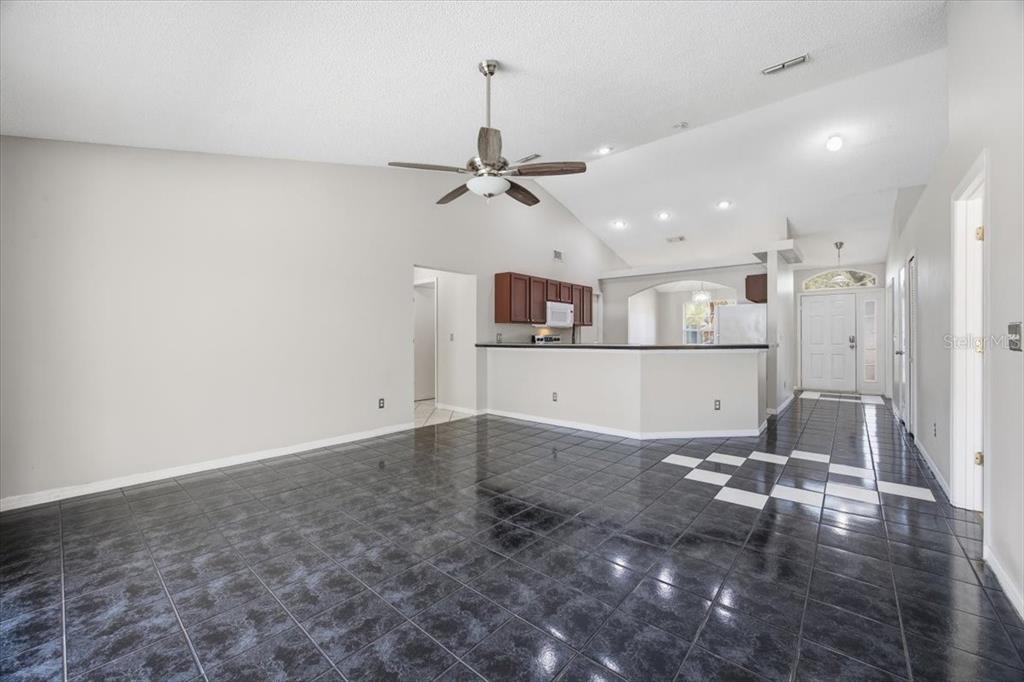 364 Nevada Loop Road Davenport, FL 33897 - Photo 11 of 26 a view of a workspace with furniture and a chandelier fan