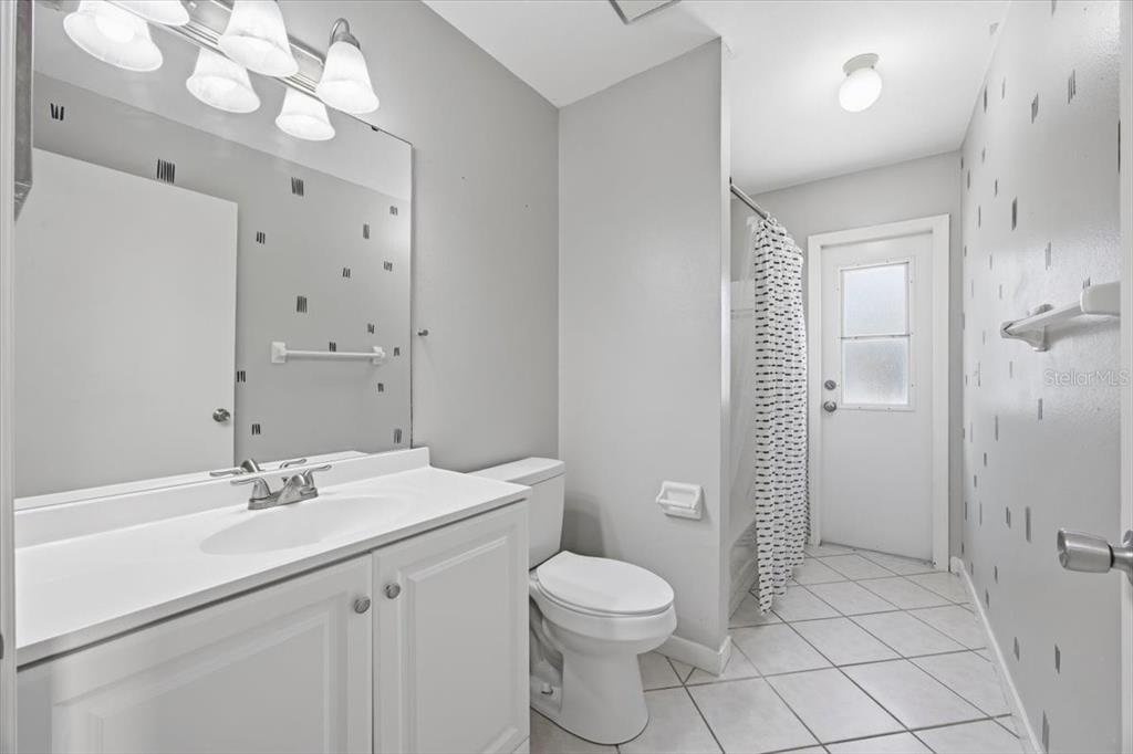 364 Nevada Loop Road Davenport, FL 33897 - Photo 14 of 26 a bathroom with a sink a toilet and shower