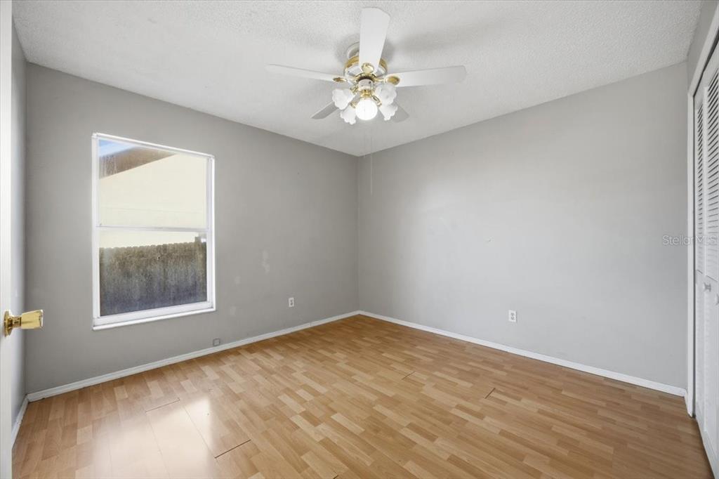 364 Nevada Loop Road Davenport, FL 33897 - Photo 15 of 26 wooden floor in an empty room with a window