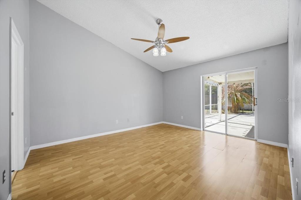 364 Nevada Loop Road Davenport, FL 33897 - Photo 18 of 26 a view of an empty room with glass door