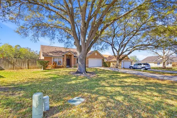 a view of a yard with a house in the background