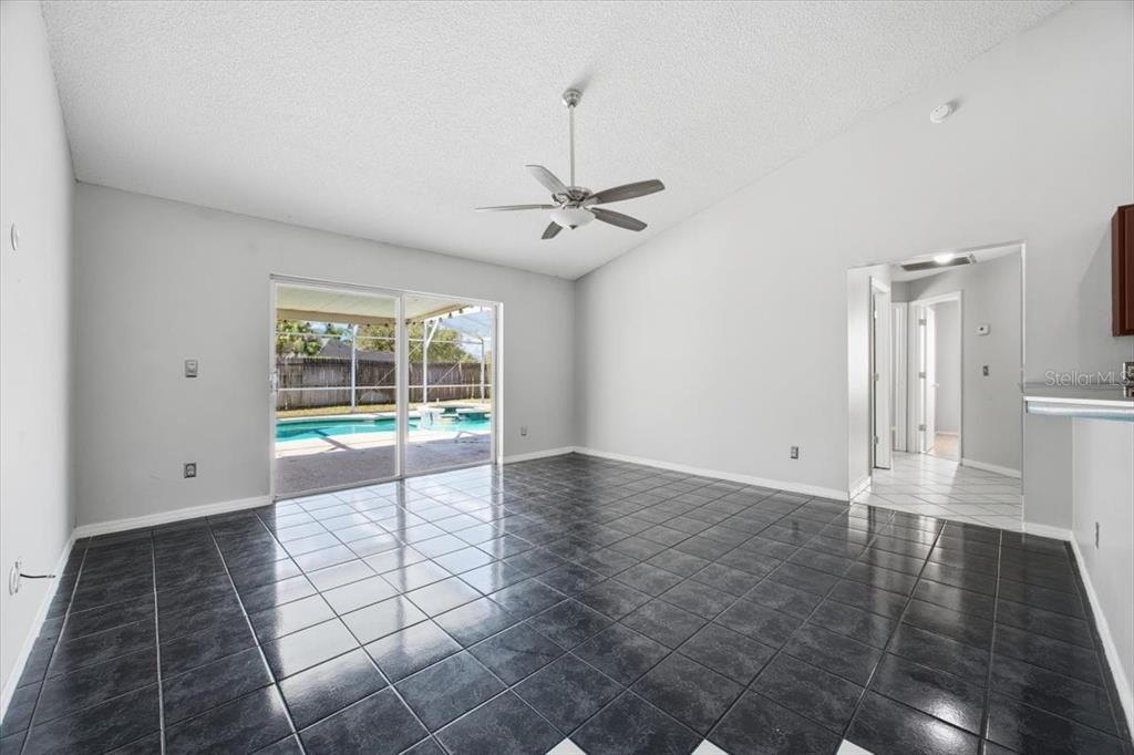 364 Nevada Loop Road Davenport, FL 33897 - Photo 10 of 26 a view of a livingroom with a furniture wooden floor and a ceiling fan