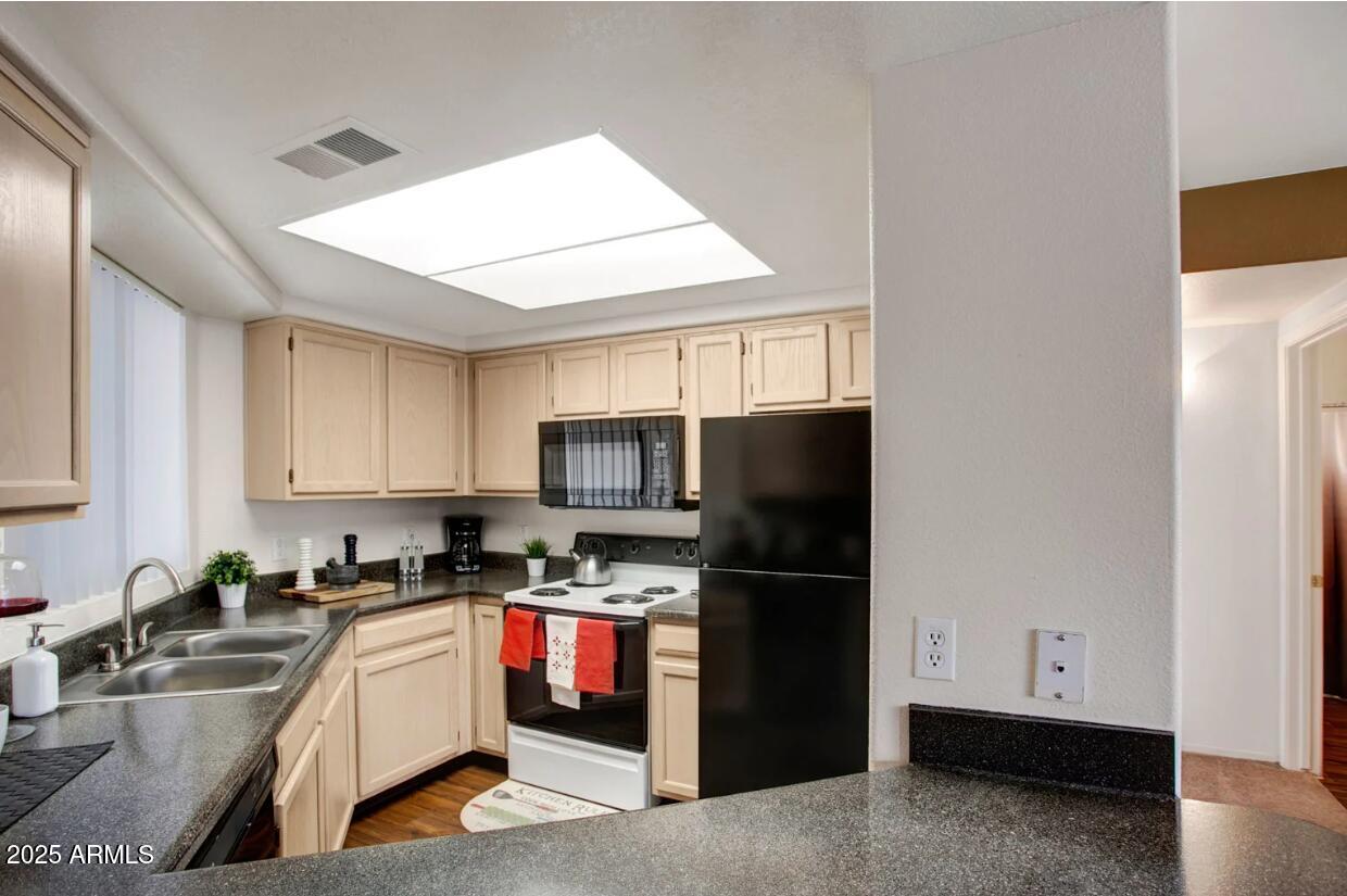 1550 East Thunderbird Road, Unit B2 Phoenix, AZ 85022 - Photo 3 of 12 a kitchen with stainless steel appliances granite countertop a refrigerator stove top oven a sink and dishwasher