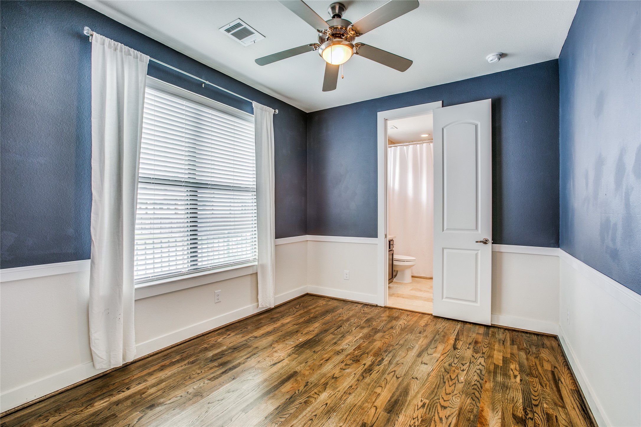 1508 Beall Street Houston, TX 77008 - Photo 7 of 38 a view of an empty room with window and wooden floor