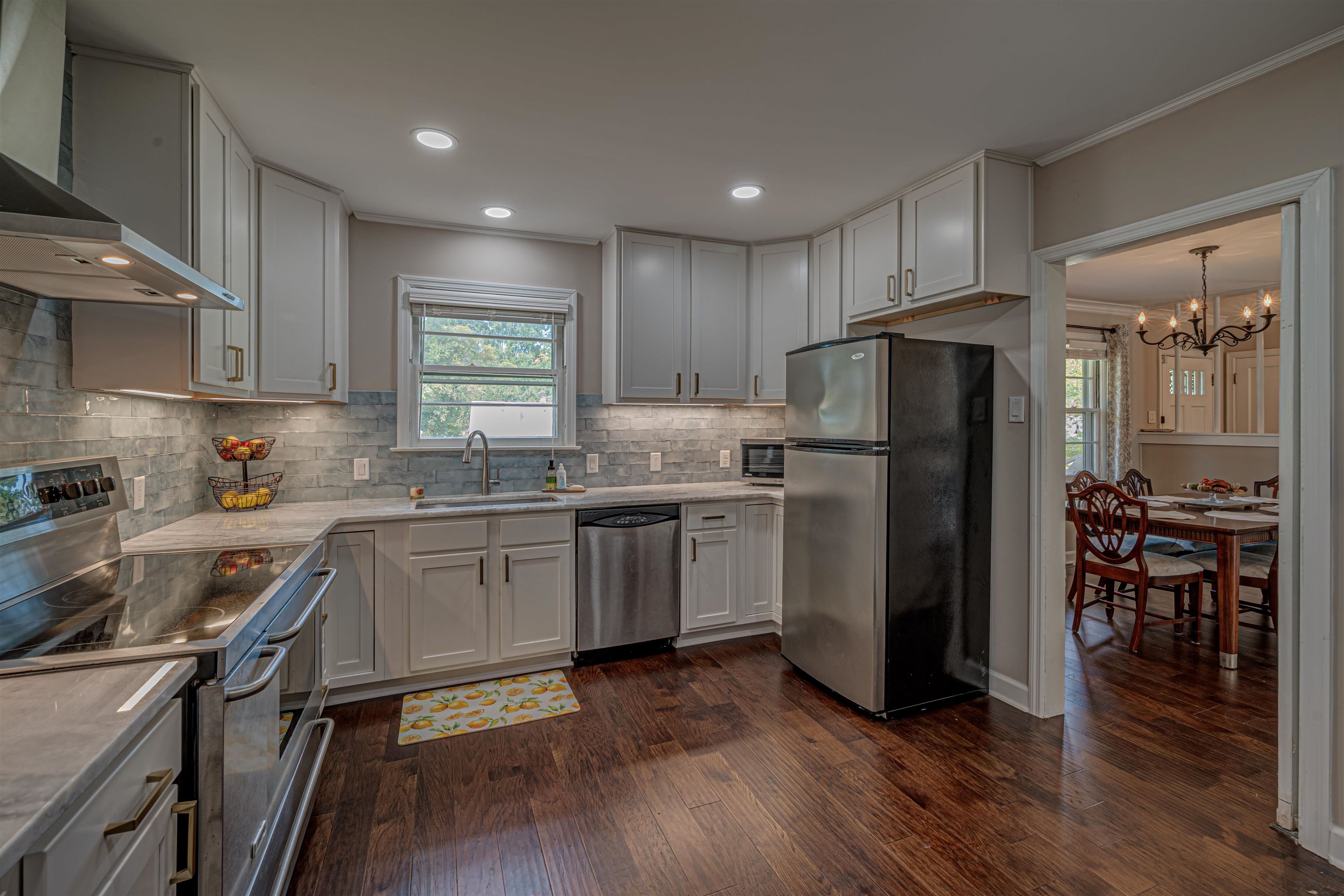 4475 Sequoia Road Memphis, TN 38117 - Photo 8 of 25 a kitchen with a refrigerator a sink a stove a microwave and cabinets