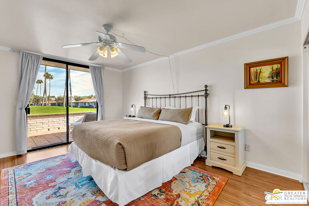 28 Calle Encinitas Rancho Mirage, CA 92270 - Photo 12 of 57 a bedroom with a bed and a lamp on dresser with wooden floor