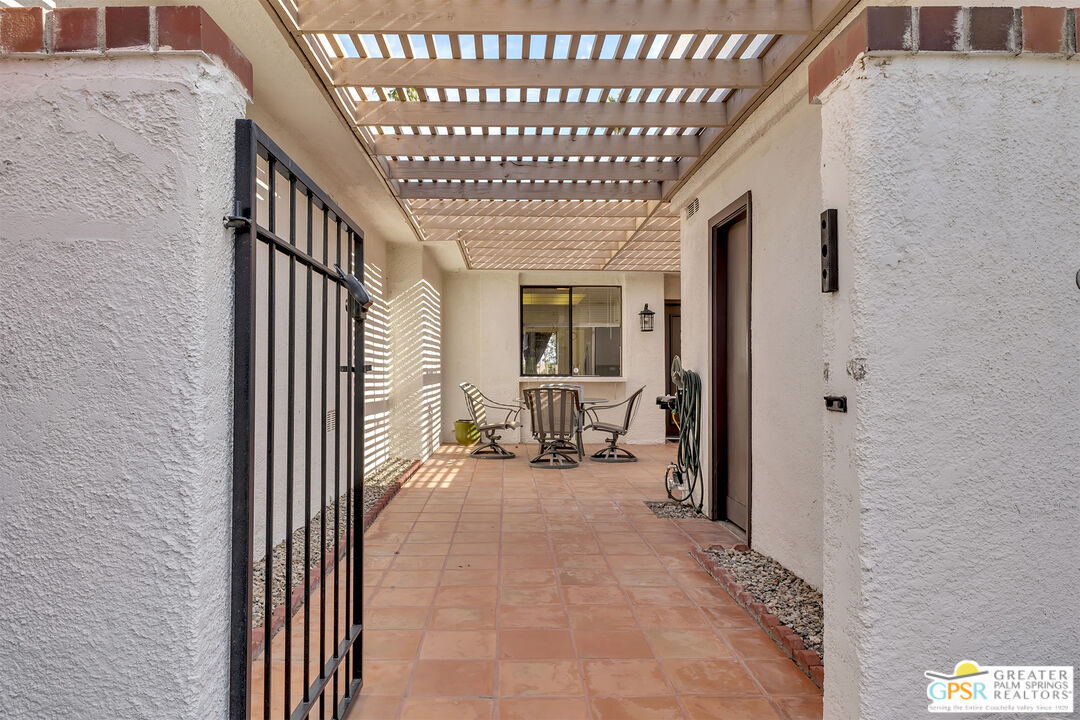 28 Calle Encinitas Rancho Mirage, CA 92270 - Photo 23 of 57 a view of a hallway with a livingroom with furniture and floor to ceiling window
