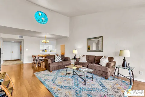 a view of a dining room with furniture and chandelier