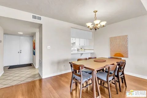 a kitchen with a sink a refrigerator and wooden cabinets