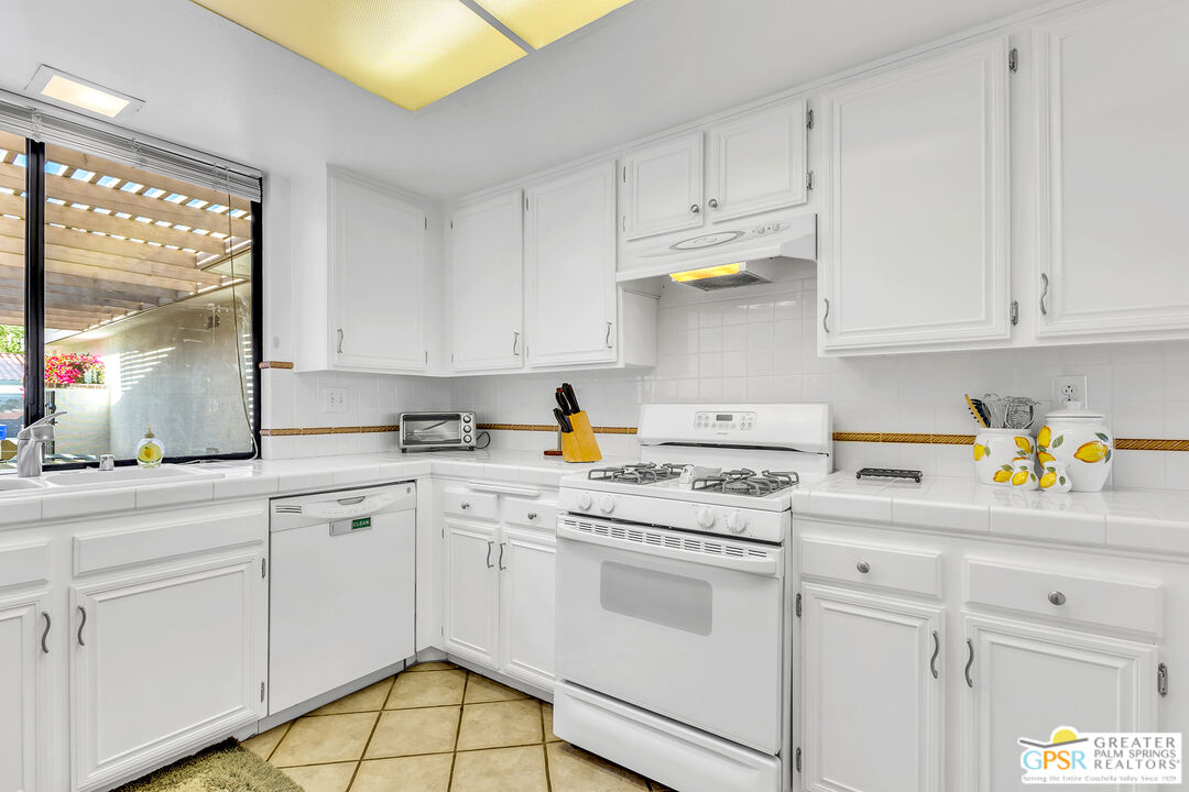 28 Calle Encinitas Rancho Mirage, CA 92270 - Photo 38 of 57 a kitchen with white cabinets and white appliances