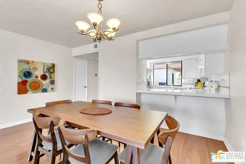 a view of a dining room with furniture and chandelier