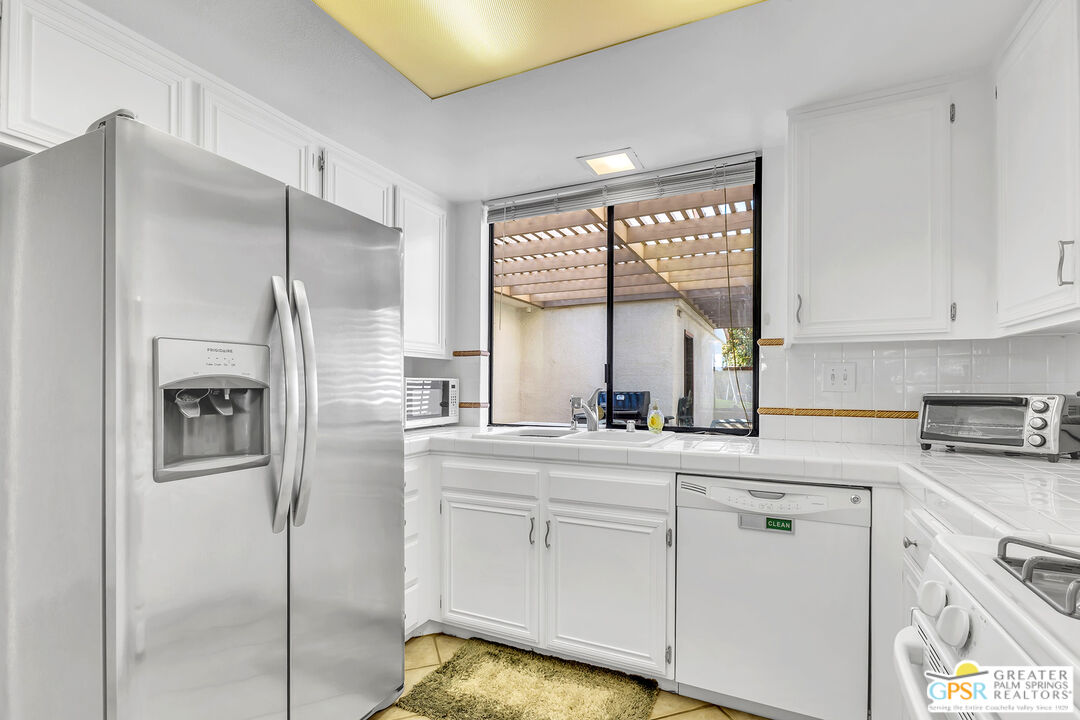 28 Calle Encinitas Rancho Mirage, CA 92270 - Photo 8 of 57 a kitchen with white cabinets and window