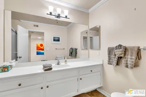 a bathroom with a sink double vanity and mirror