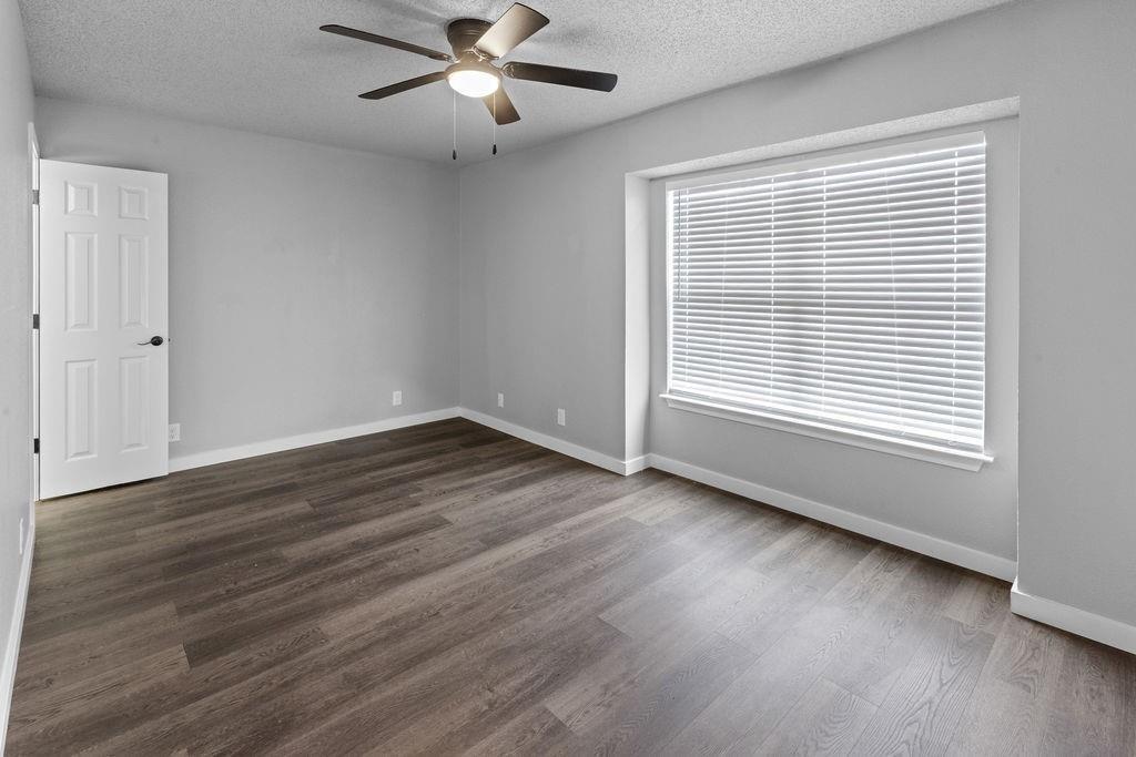 709 East Crawford Street Denison, TX 75021 - Photo 12 of 13 wooden floor in an empty room with a window