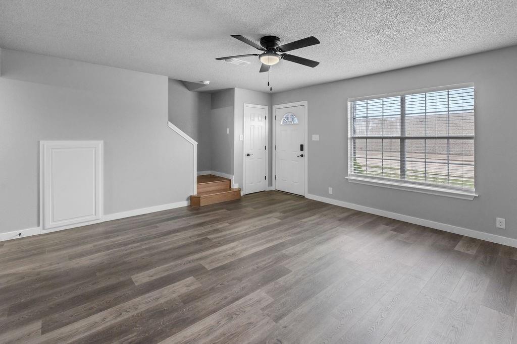 709 East Crawford Street Denison, TX 75021 - Photo 3 of 13 wooden floor in an empty room with a window