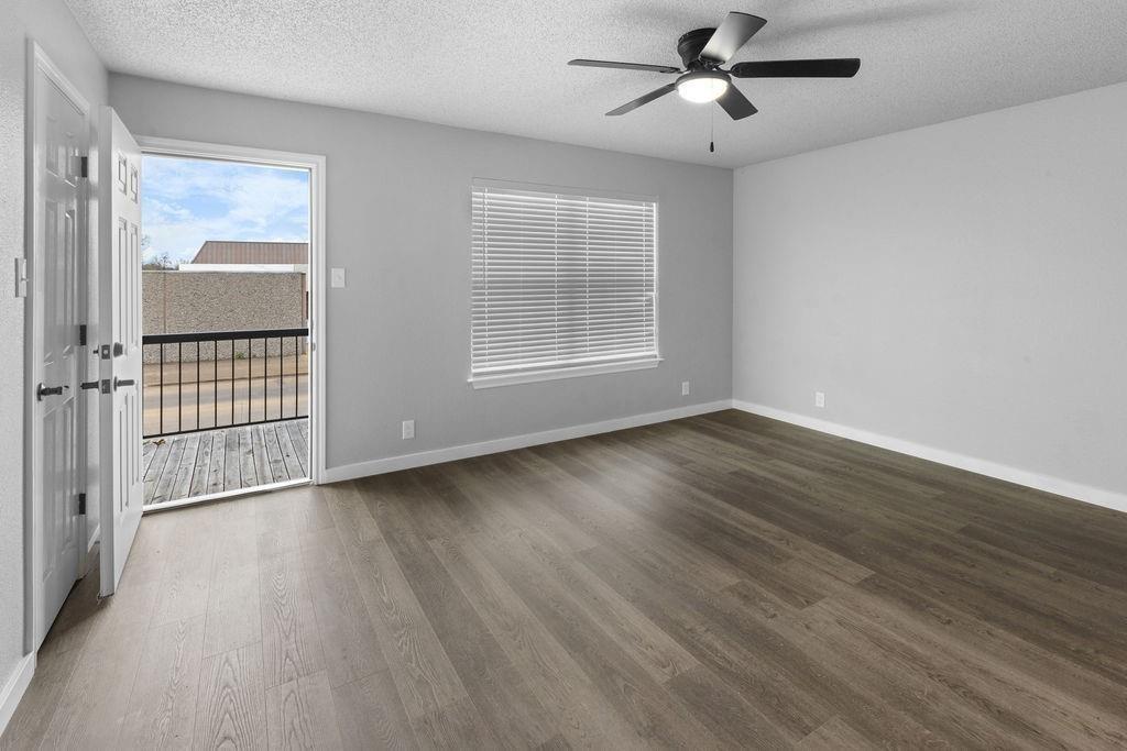 709 East Crawford Street Denison, TX 75021 - Photo 8 of 13 wooden floor in an empty room with a window