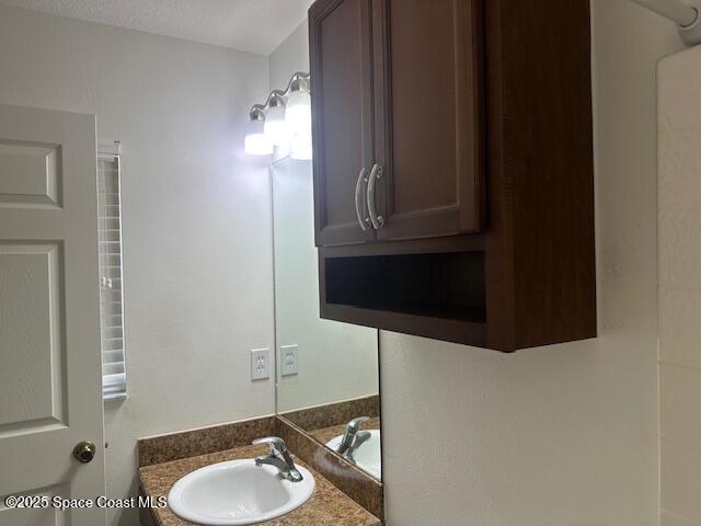 5632 Talbot Boulevard Cocoa, FL 32926 - Photo 6 of 12 a bathroom with a sink and a mirror