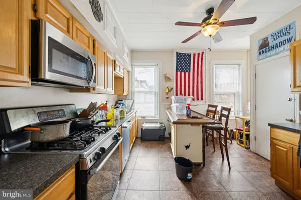 a kitchen with a stove a sink and a refrigerator