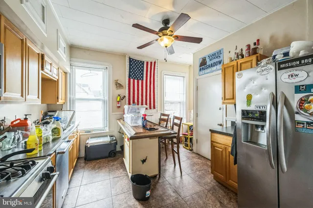 a view of a kitchen with dining table and chairs