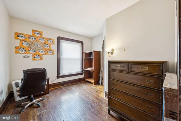 a view of room with wooden floor and furniture