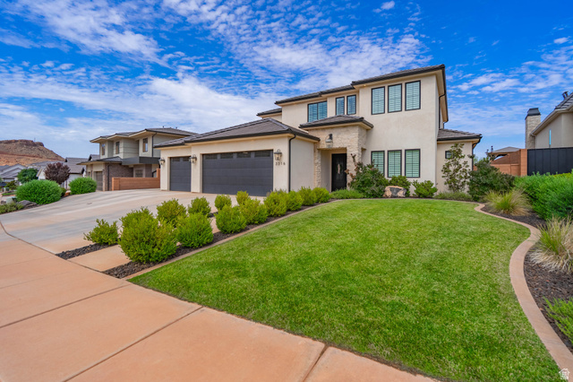 3166 South Tallow Tree Drive St. George, UT 84790 - Photo 1 of 32 Contemporary stucco exterior featuring dark-framed windows and a stone accent facade