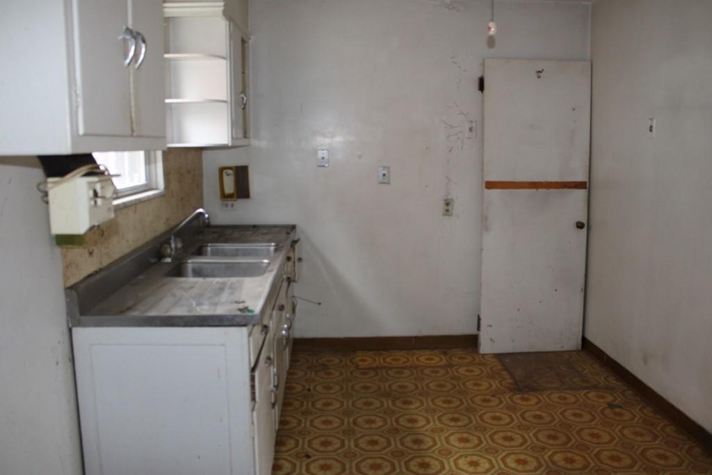 825 Liberty Street Duquesne, PA 15110 - Photo 8 of 25 a kitchen with a sink and a refrigerator
